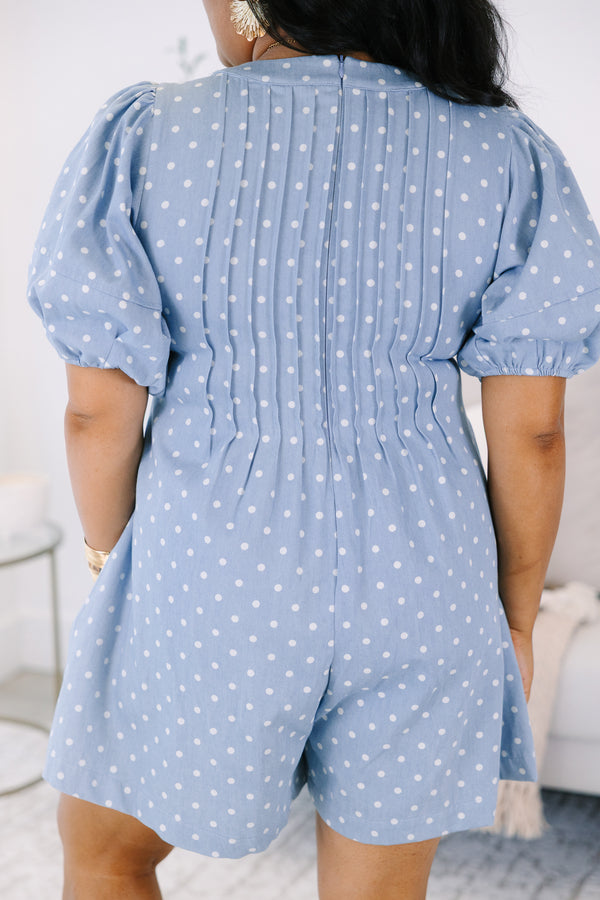Plus size blue polka dot romper with a keyhole tie front, puff sleeves, and a flowy fit.