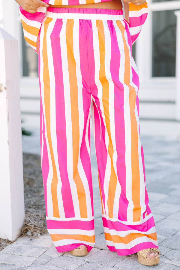 Chic Soul plus size clothing, pink orange and white striped pants with a stretchy waistband as well as a cuff at the bottom of each pant leg that has horizontal stripes 