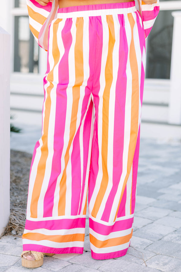 Chic Soul plus size clothing, pink orange and white striped pants with a stretchy waistband as well as a cuff at the bottom of each pant leg that has horizontal stripes 