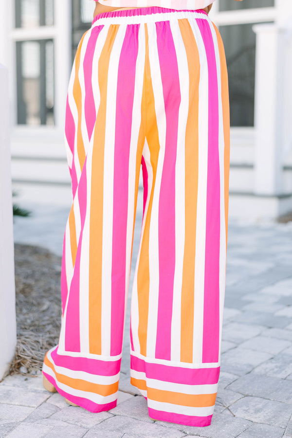 Chic Soul plus size clothing, pink orange and white striped pants with a stretchy waistband as well as a cuff at the bottom of each pant leg that has horizontal stripes 