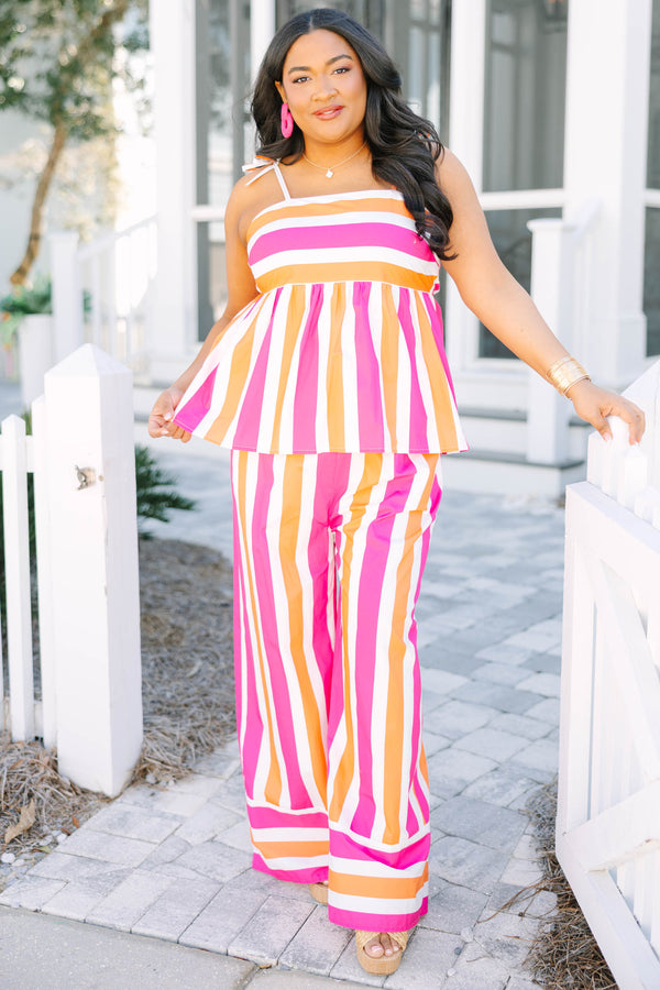 Chic Soul plus size clothing, pink orange and white striped pants with a stretchy waistband as well as a cuff at the bottom of each pant leg that has horizontal stripes 