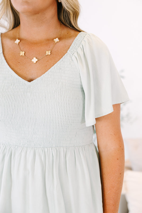 Plus Size sage green smocked peplum top with a V-neckline and flutter sleeves.
