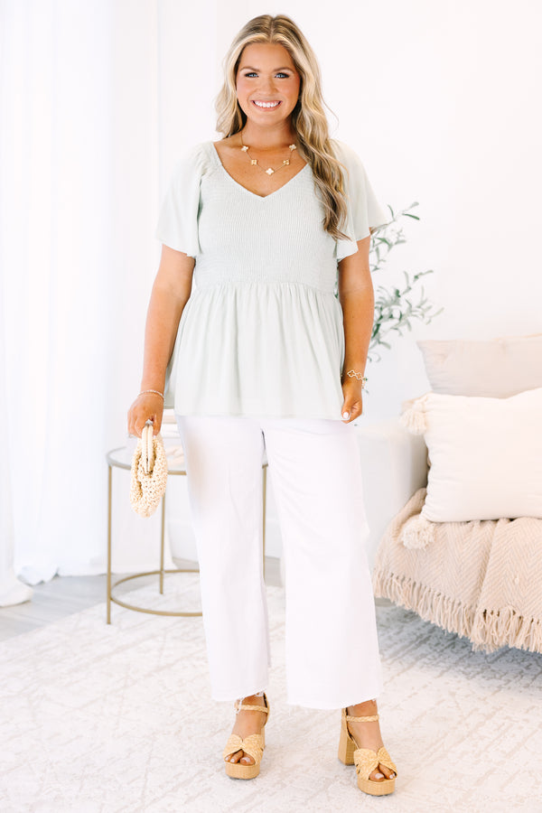 Plus Size sage green smocked peplum top with a V-neckline and flutter sleeves.