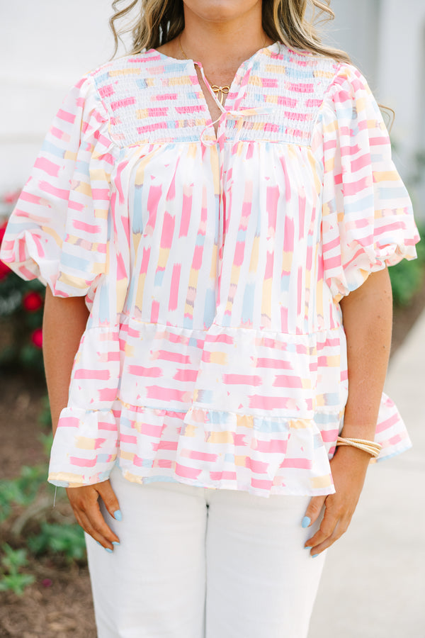 Chic Soul plus size clothing, flowy white top with multicolored abstract design with short bubble sleeves and a slight v-neckline as well as a smocked texture on the shoulder area 