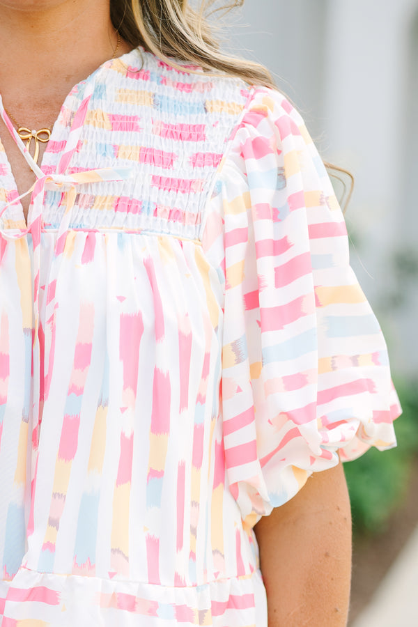 Chic Soul plus size clothing, flowy white top with multicolored abstract design with short bubble sleeves and a slight v-neckline as well as a smocked texture on the shoulder area 