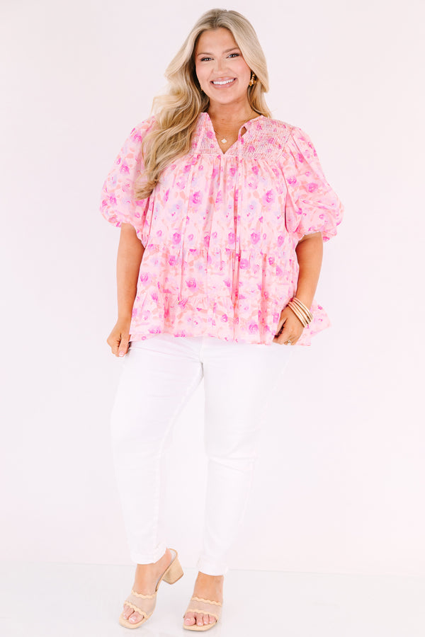 Chic Soul plus size clothing, pink floral flowy top with short bubble sleeves and a slight v-neckline as well as a smocked texture on the shoulder area 