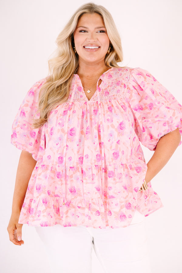 Chic Soul plus size clothing, pink floral flowy top with short bubble sleeves and a slight v-neckline as well as a smocked texture on the shoulder area 