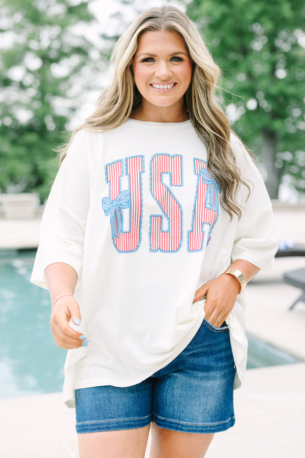 Chic Soul Plus Size Clothing, white short sleeve t-shirt with American flag print text graphic, featuring two blue bows, in front center that says 