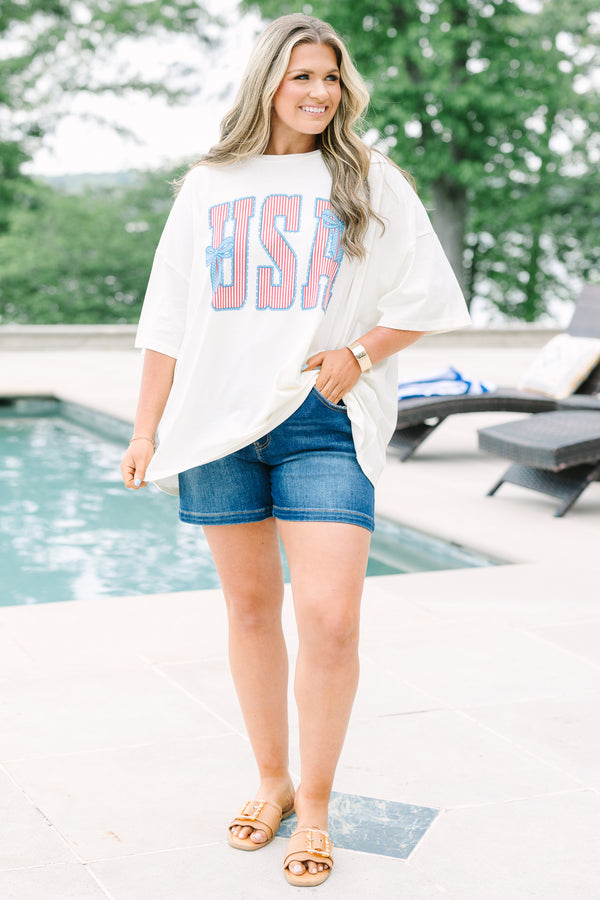 Chic Soul Plus Size Clothing, white short sleeve t-shirt with American flag print text graphic, featuring two blue bows, in front center that says 