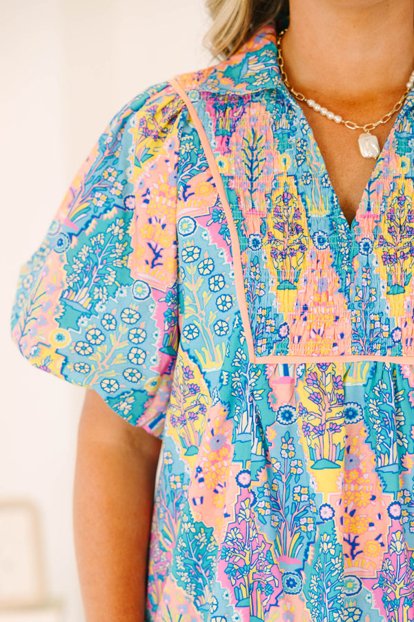 Plus size dress in blue multi color pattern, featuring a flowy fit and vibrant floral pattern.