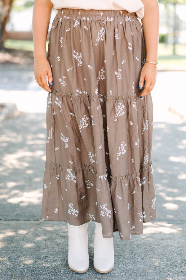 Plus Size brown tiered maxi skirt with a white floral print and elastic waistband.