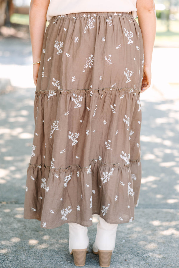 Plus Size brown tiered maxi skirt with a white floral print and elastic waistband.