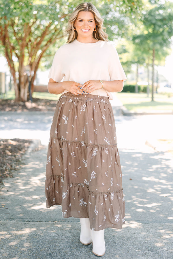 Plus Size brown tiered maxi skirt with a white floral print and elastic waistband.