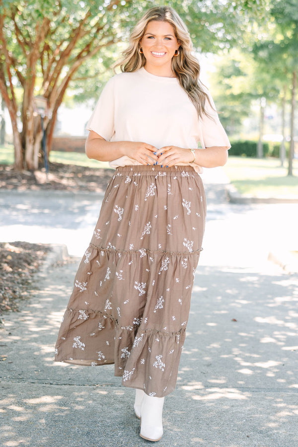 Plus Size brown tiered maxi skirt with a white floral print and elastic waistband.
