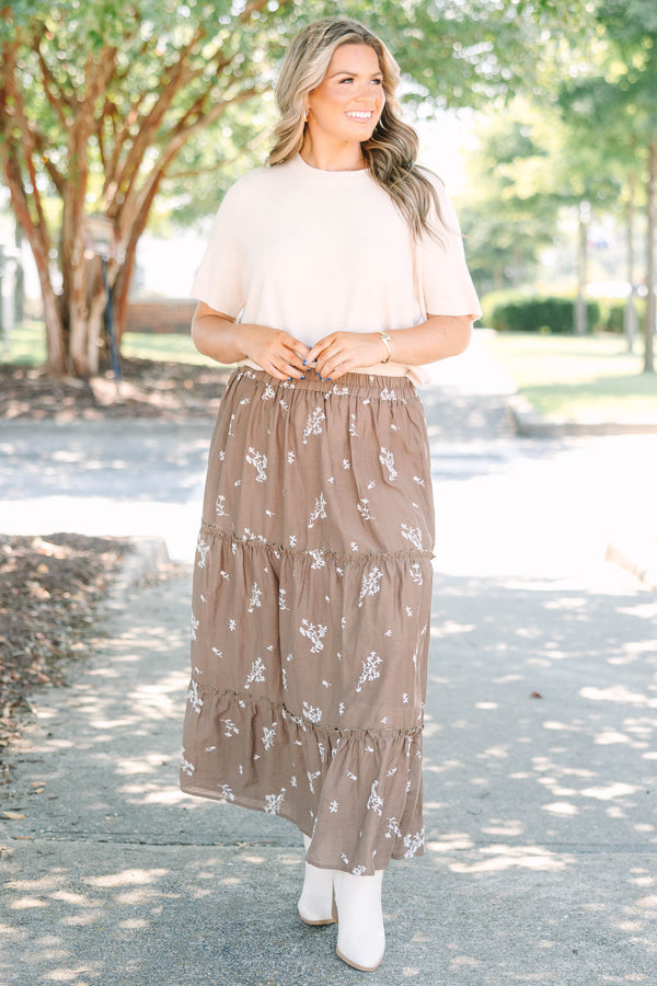 Plus Size brown tiered maxi skirt with a white floral print and elastic waistband.