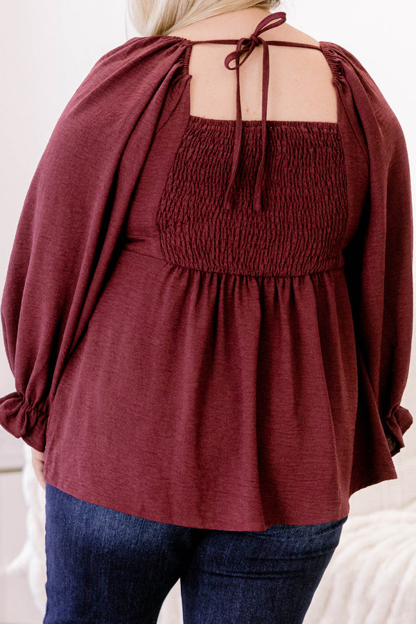 Chic Soul plus size clothing, maroon long sleeve flowy baby doll blouse with a structured v neckline and ruffles on the ends of the sleeves