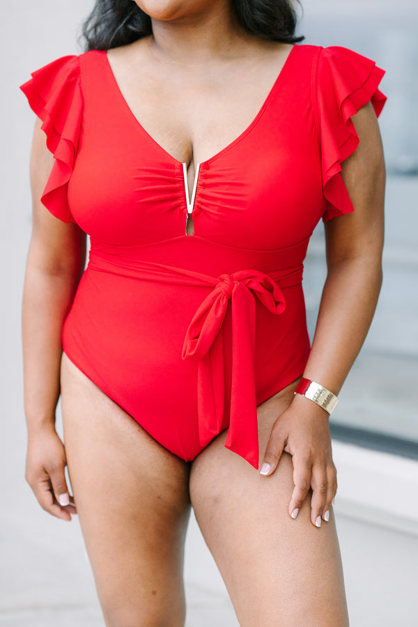 Plus Size red one-piece swimsuit with flutter sleeves, gold hardware, and a tie-waist sash.