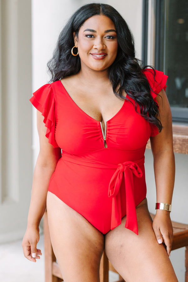 Plus Size red one-piece swimsuit with flutter sleeves, gold hardware, and a tie-waist sash.