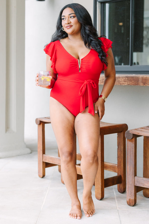 Plus Size red one-piece swimsuit with flutter sleeves, gold hardware, and a tie-waist sash.