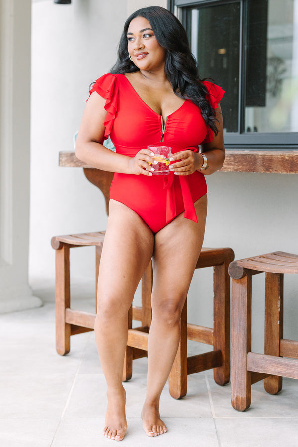 Plus Size red one-piece swimsuit with flutter sleeves, gold hardware, and a tie-waist sash.