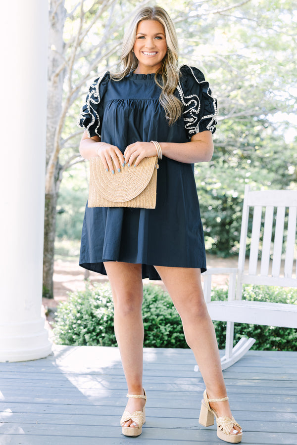 Navy cotton mini dress with ruffled puff sleeves, white embroidery, and a high neckline.