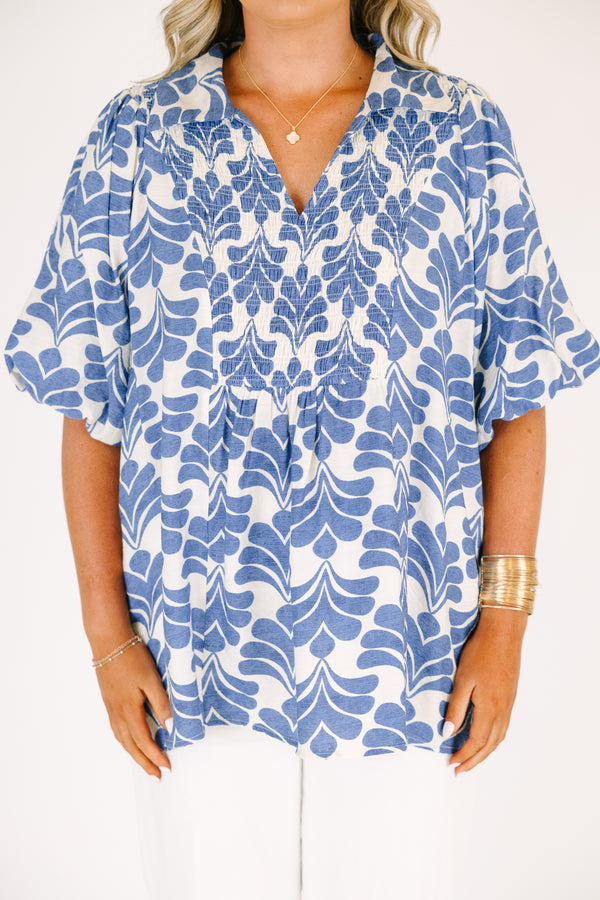 Plus Size blue and white abstract print top with a v-neck, smocked bodice, and puff sleeves.