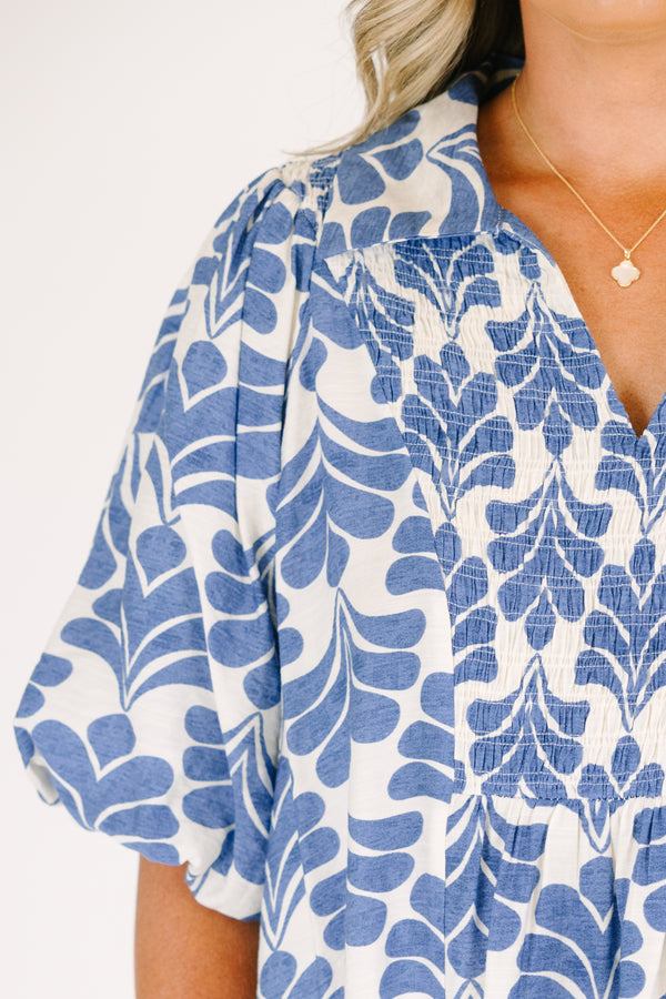 Plus Size blue and white abstract print top with a v-neck, smocked bodice, and puff sleeves.