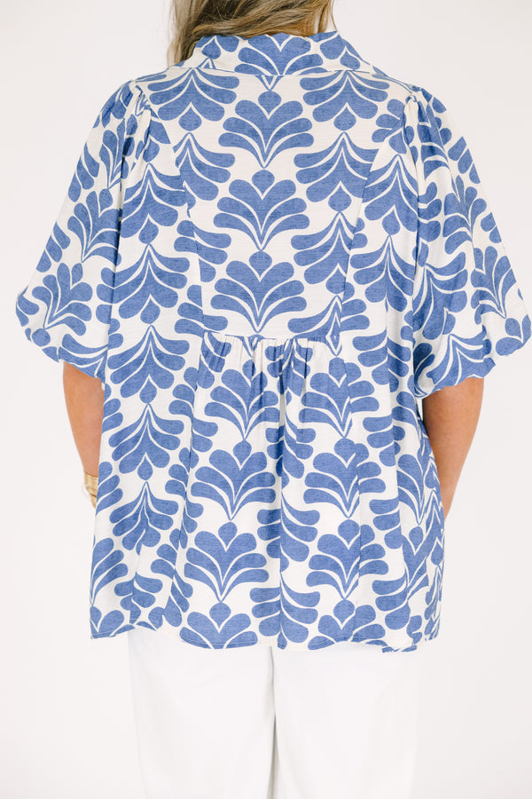 Plus Size blue and white abstract print top with a v-neck, smocked bodice, and puff sleeves.