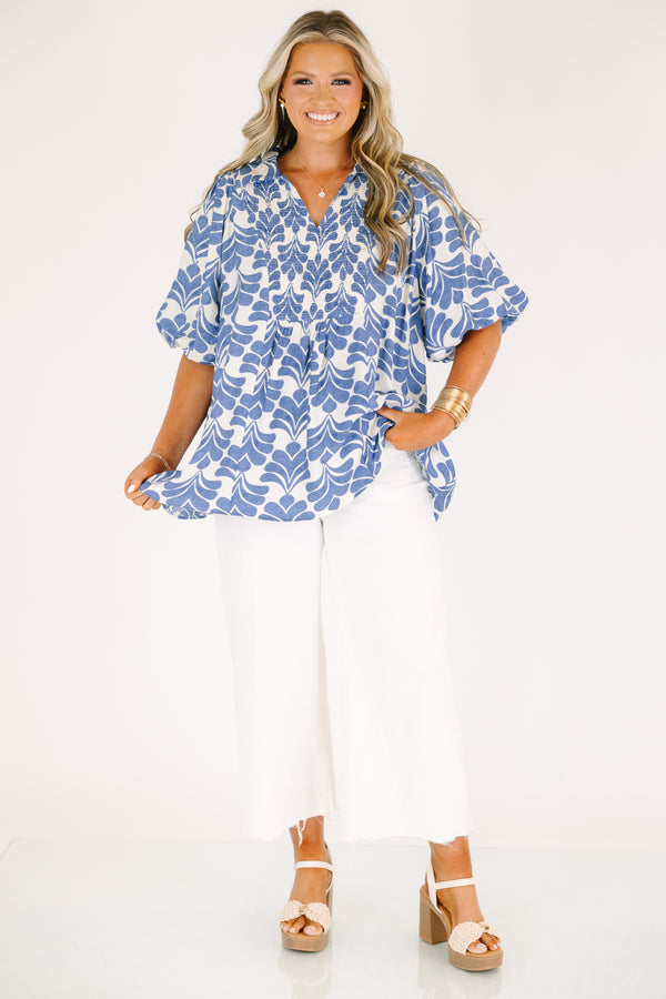 Plus Size blue and white abstract print top with a v-neck, smocked bodice, and puff sleeves.