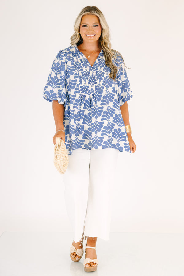 Plus Size blue and white abstract print top with a v-neck, smocked bodice, and puff sleeves.