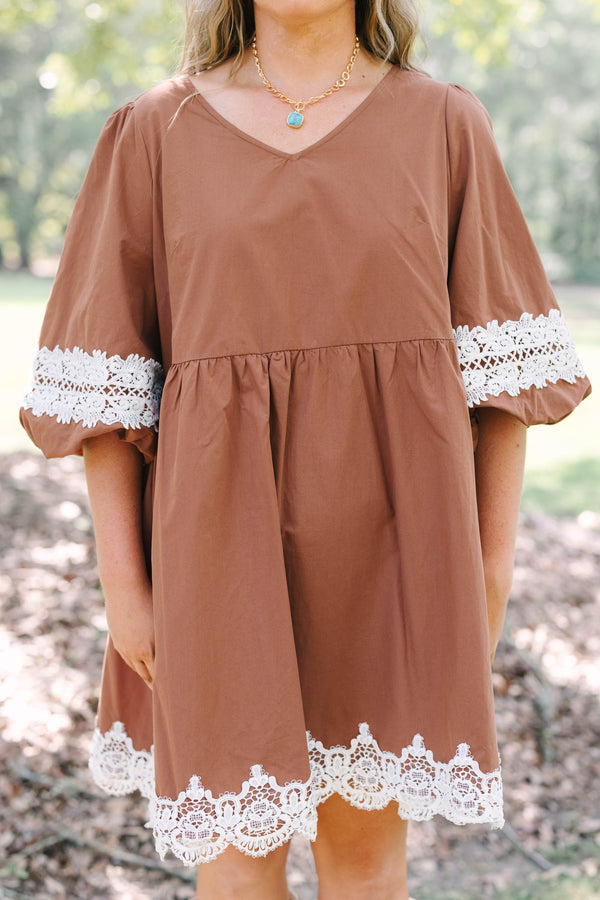 Plus size brown babydoll mini dress with puff sleeves and white crochet lace trim on hem and cuffs.