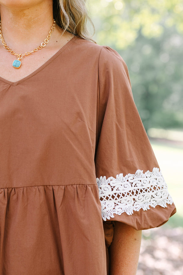 Plus size brown babydoll mini dress with puff sleeves and white crochet lace trim on hem and cuffs.