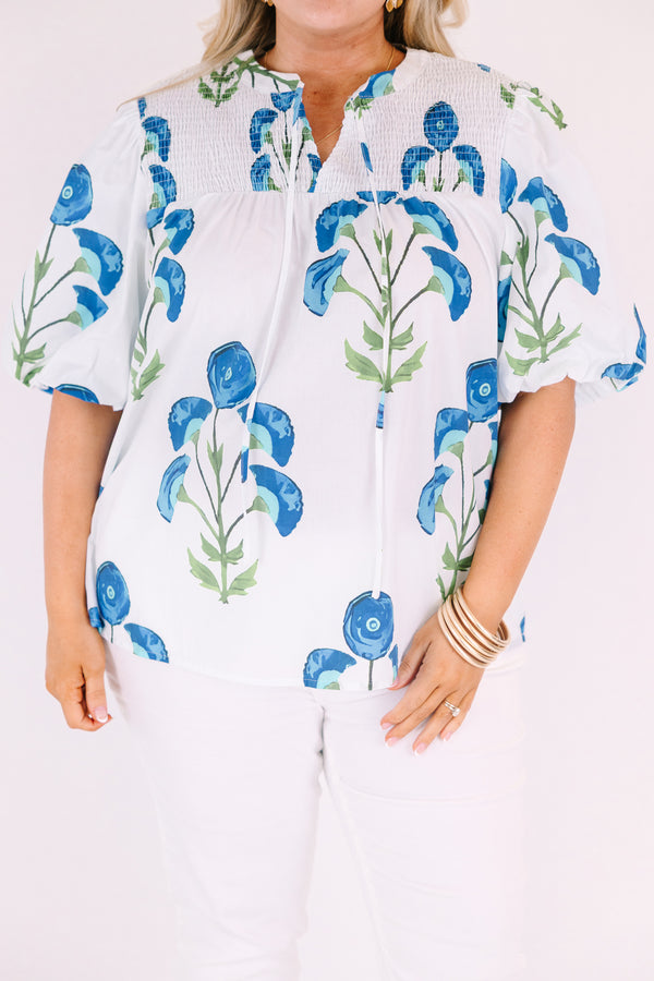 Chic Soul plus size clothing, White puff sleeve baby doll top with blue and green flowers on it and ruching texturing on the top of the shoulders and tassels hanging from the neckline