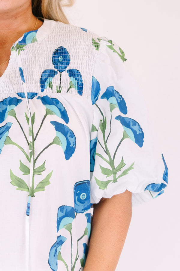 Chic Soul plus size clothing, White puff sleeve baby doll top with blue and green flowers on it and ruching texturing on the top of the shoulders and tassels hanging from the neckline