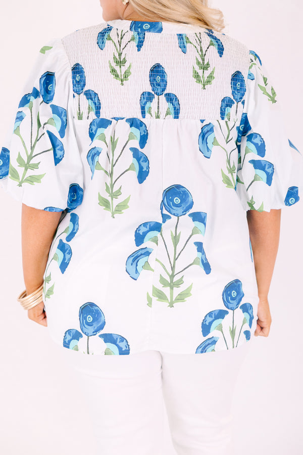 Chic Soul plus size clothing, White puff sleeve baby doll top with blue and green flowers on it and ruching texturing on the top of the shoulders and tassels hanging from the neckline