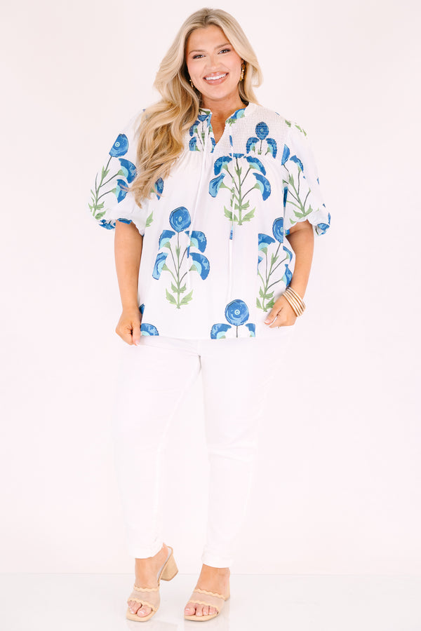 Chic Soul plus size clothing, White puff sleeve baby doll top with blue and green flowers on it and ruching texturing on the top of the shoulders and tassels hanging from the neckline