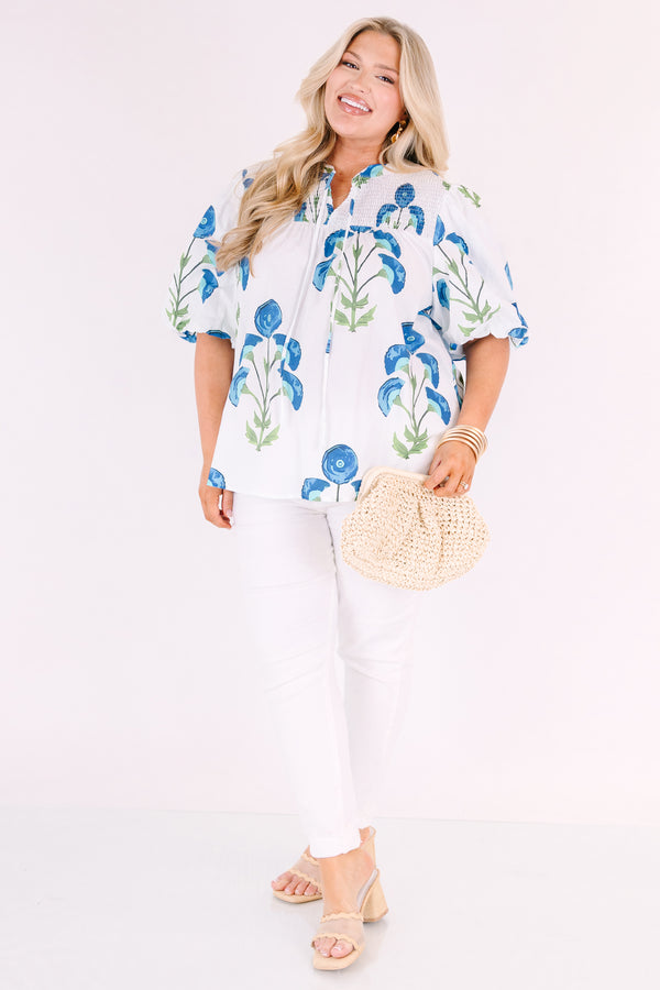 Chic Soul plus size clothing, White puff sleeve baby doll top with blue and green flowers on it and ruching texturing on the top of the shoulders and tassels hanging from the neckline