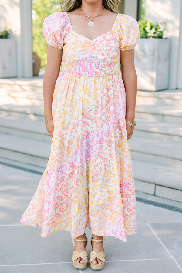 Plus size floral maxi dress with puff sleeves, smocked bodice, and tiered design in pink and orange.
