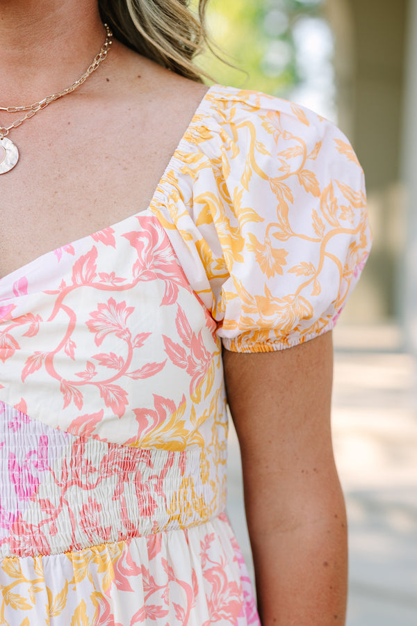 Plus size floral maxi dress with puff sleeves, smocked bodice, and tiered design in pink and orange.