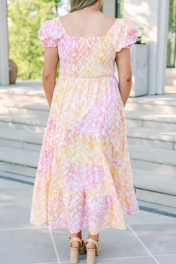 Plus size floral maxi dress with puff sleeves, smocked bodice, and tiered design in pink and orange.
