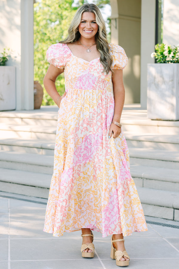 Plus size floral maxi dress with puff sleeves, smocked bodice, and tiered design in pink and orange.