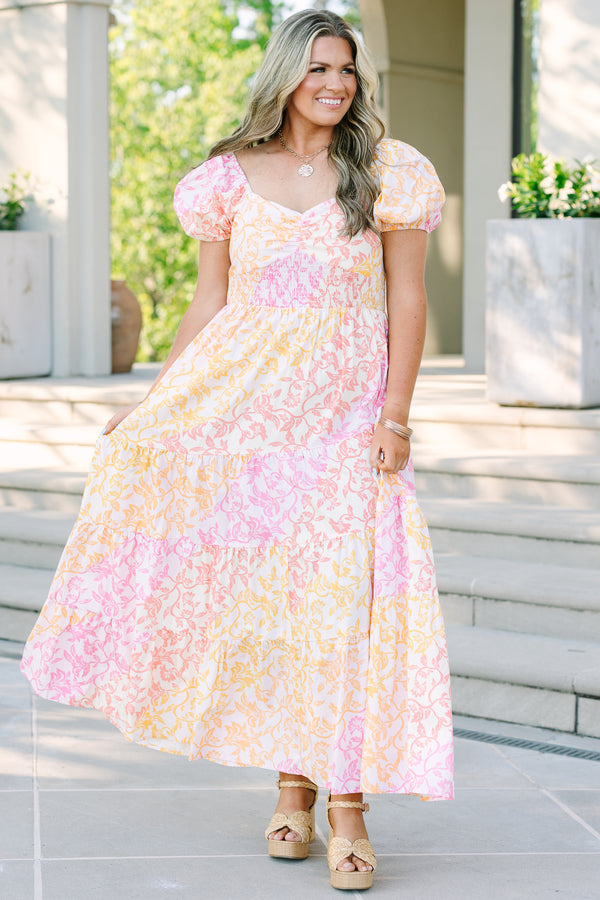 Plus size floral maxi dress with puff sleeves, smocked bodice, and tiered design in pink and orange.