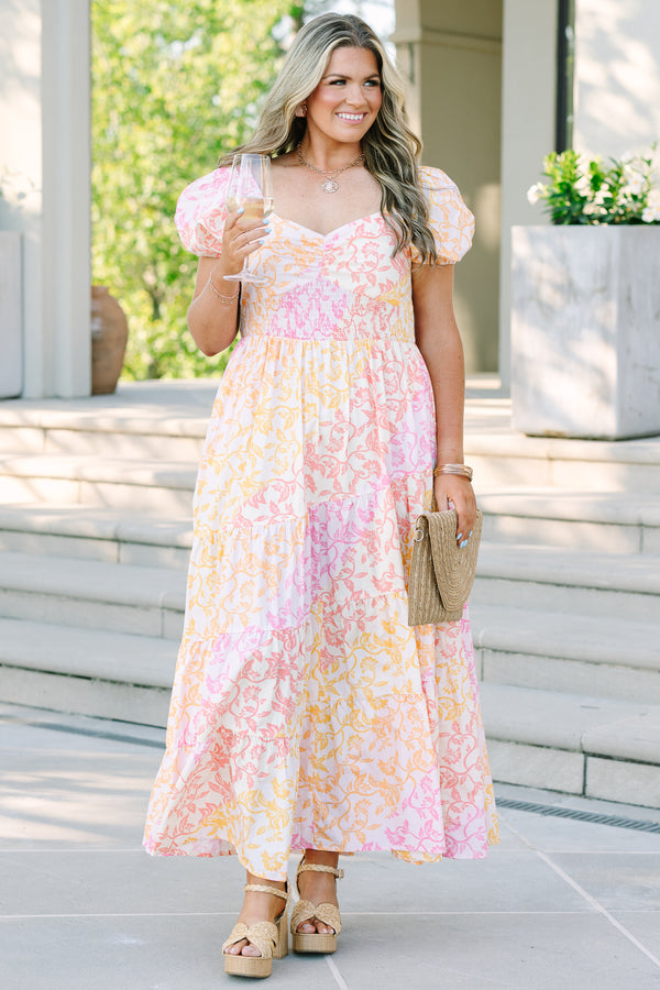 Plus size floral maxi dress with puff sleeves, smocked bodice, and tiered design in pink and orange.