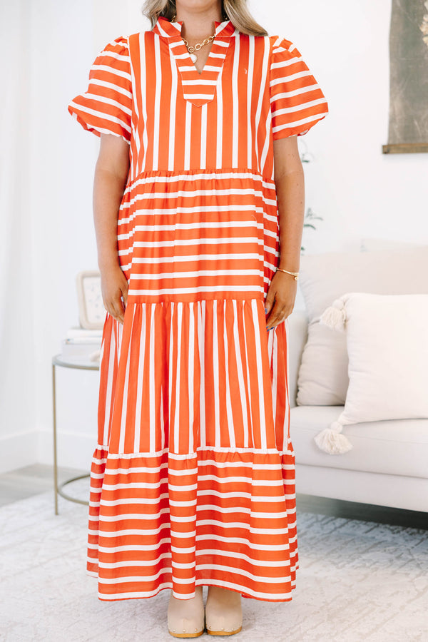 Plus size orange and white striped tiered maxi dress with puff sleeves and a flowy fit.