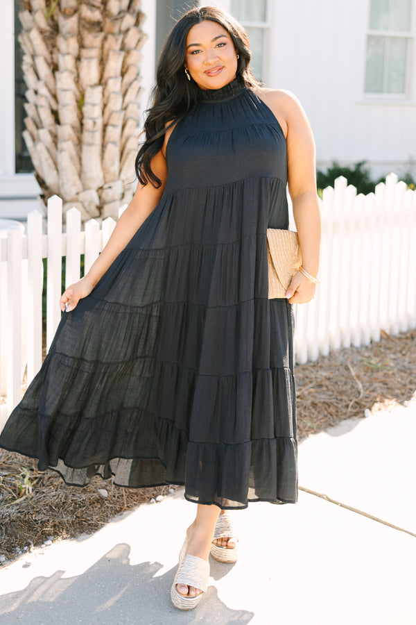Chic Soul plus size clothing, tiered black maxi dress with a high neck that has ruffle detailing on the neckline and a bow that ties on the back of the neck at the top 