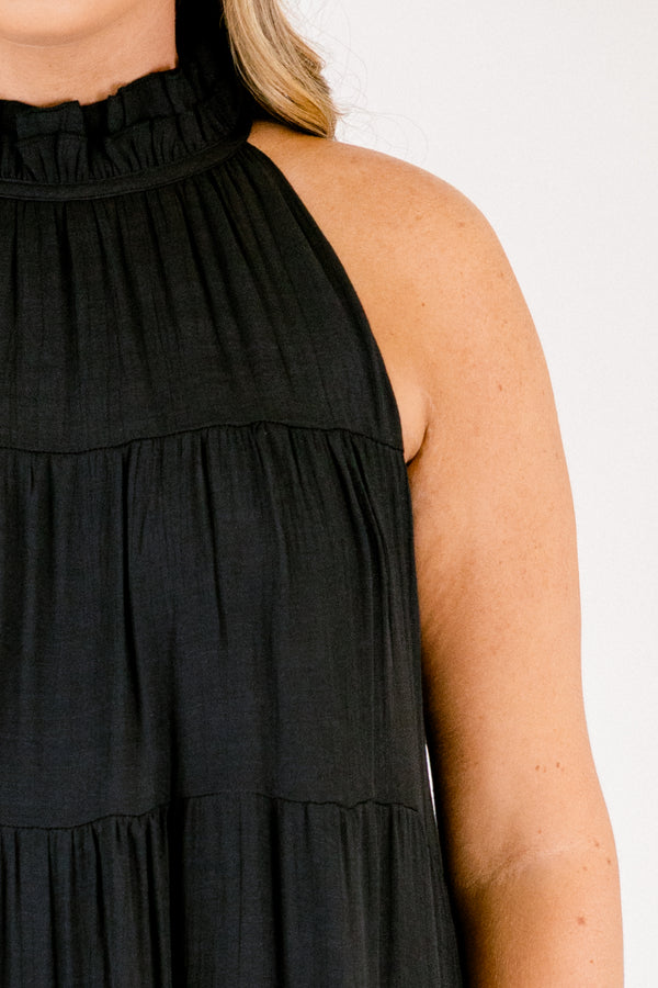 Chic Soul plus size clothing, tiered black maxi dress with a high neck that has ruffle detailing on the neckline and a bow that ties on the back of the neck at the top 