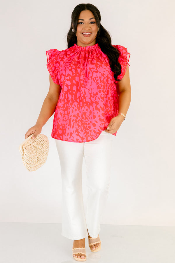 Chic Soul plus size clothing, fuchsia top with a high neck that has ruffle detailing as well as flutter sleeves and a pink abstract pattern throughout 