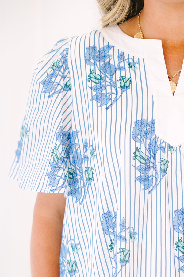 Plus Size blue and white striped shift dress with a floral print, V-neckline, and flutter sleeves.