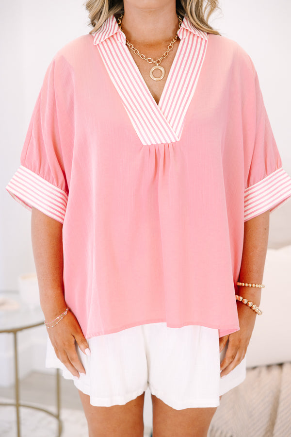 Plus Size pink v-neck top with striped trim on the collar and short sleeves.