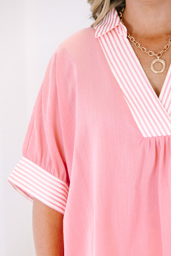 Plus Size pink v-neck top with striped trim on the collar and short sleeves.